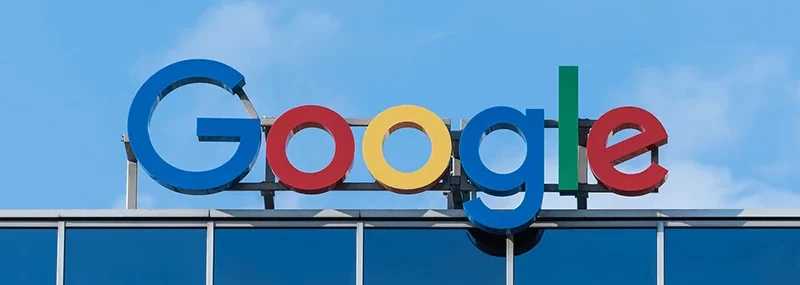 The image shows the Google logo displayed on top of a building.