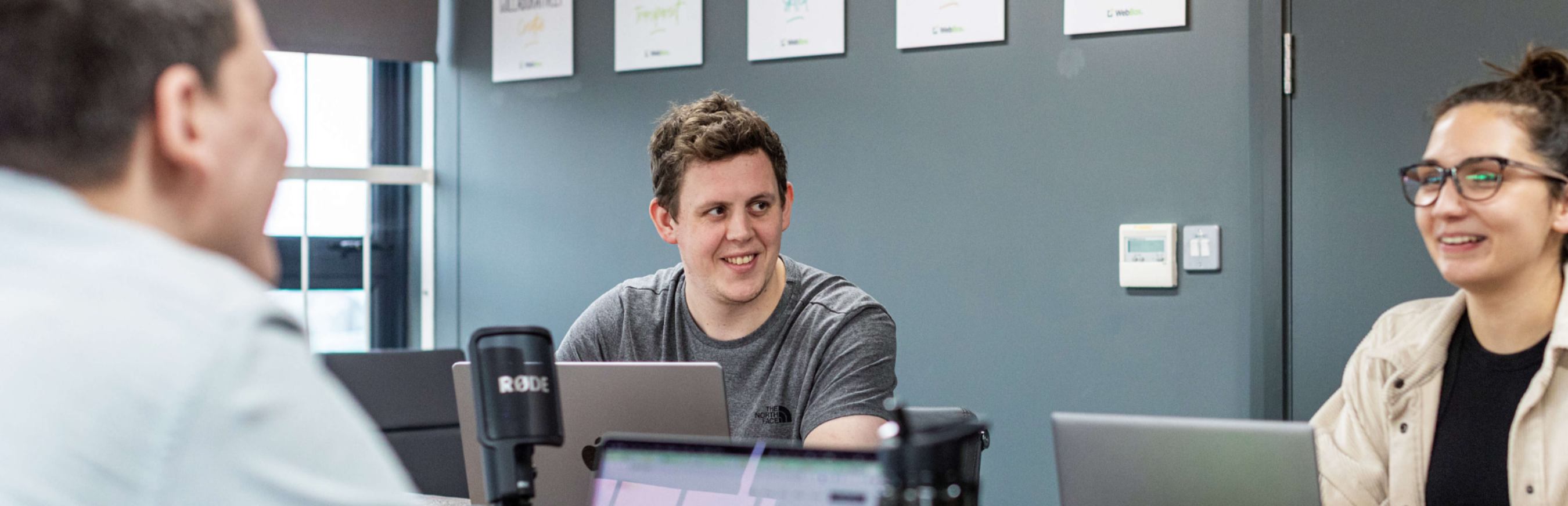 Employee smiling in meeting with colleagues